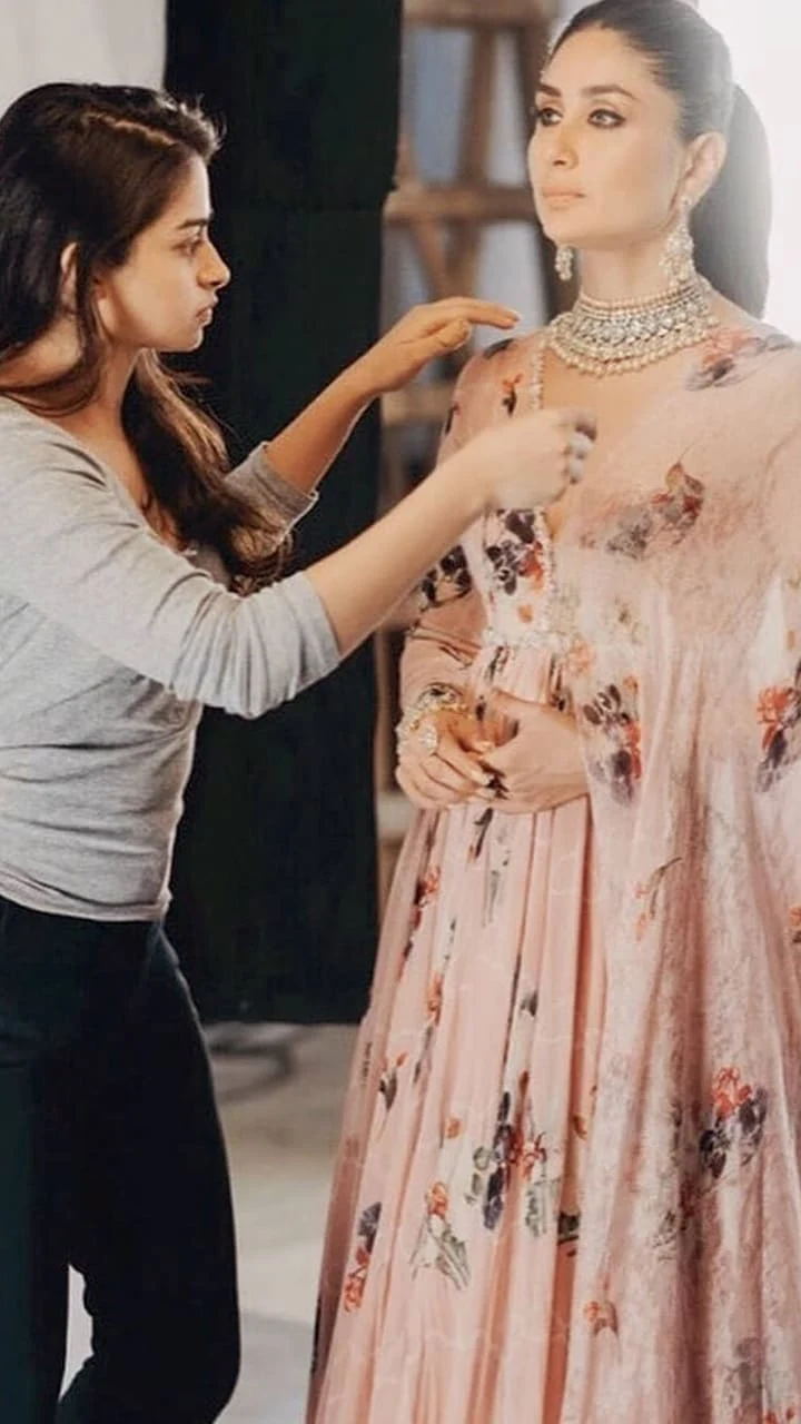  Stylist dressing celebrity for photoshoot